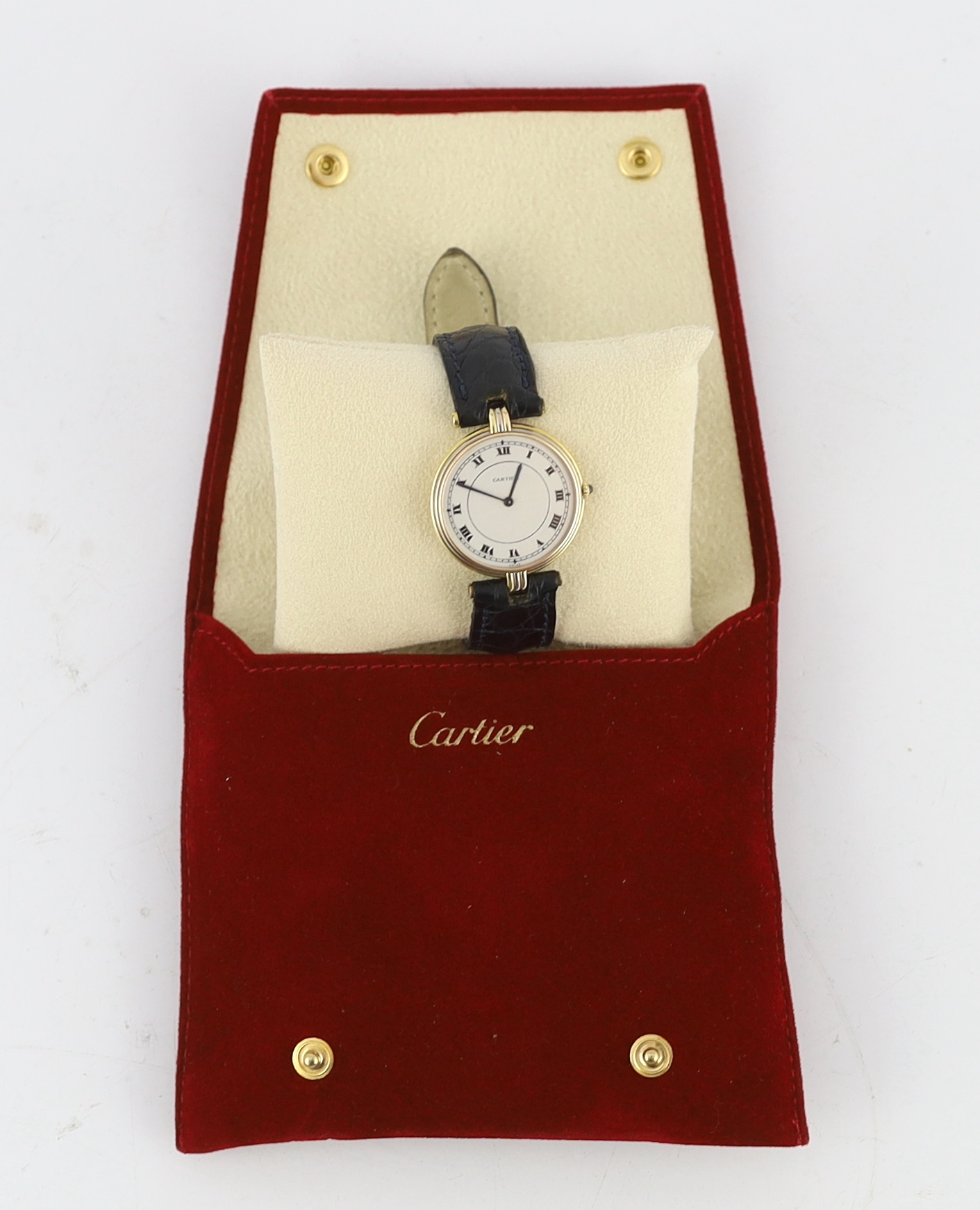 A lady's modern Cartier 18k gold quartz wrist watch, on associated leather strap and buckle